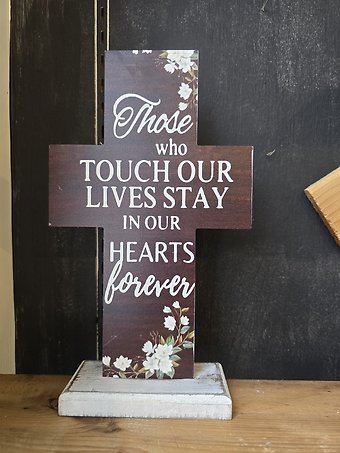 Cross with blue flowers, in our hearts forever